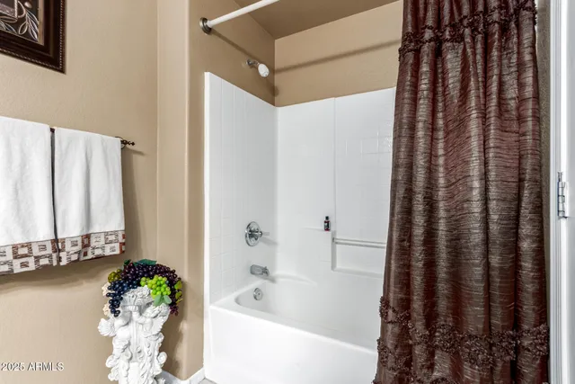a bath room with a bathtub and a shower