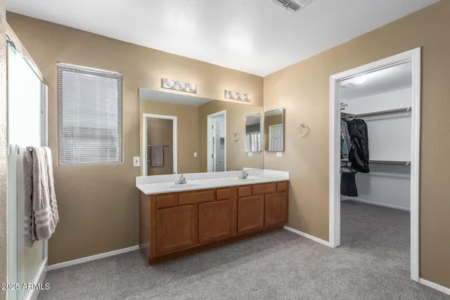 a spacious bathroom with a double vanity sink and a mirror