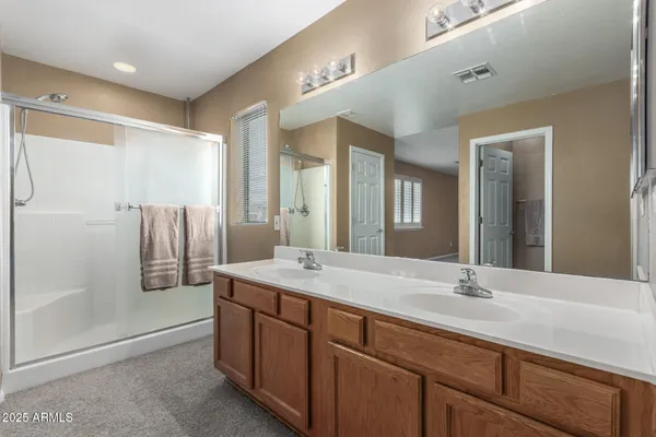 a bathroom with a granite countertop sink mirror and double
