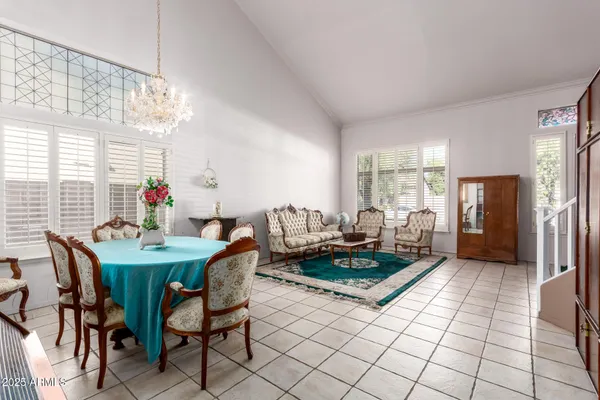 a view of a dining room with furniture and a chandelier