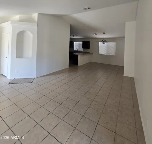 an empty room with fireplace and windows