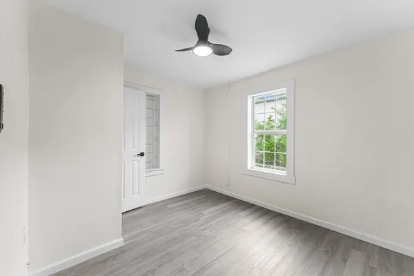 wooden floor in an empty room with a window