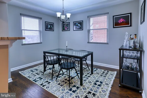 a view of a dining room with furniture and chandelier