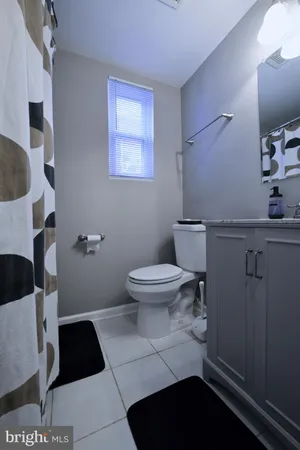 a bathroom with a toilet and a mirror