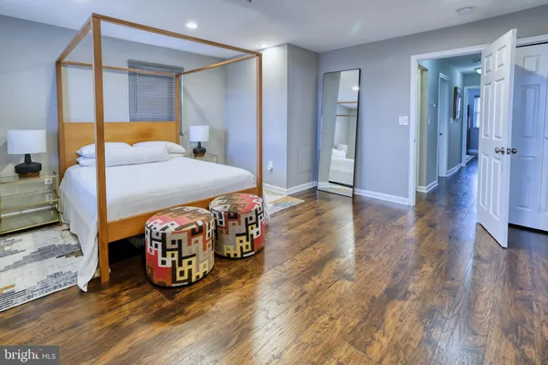 a bedroom with bed and wooden floor