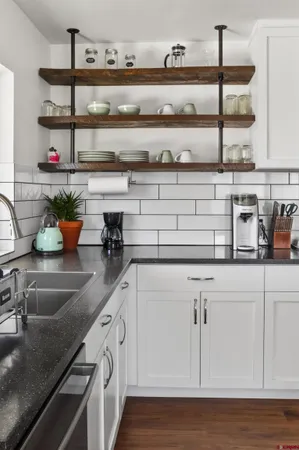 a kitchen with stainless steel appliances granite countertop a sink and cabinets