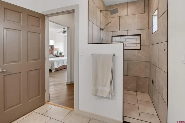 a bathroom with a glass shower door and a sink