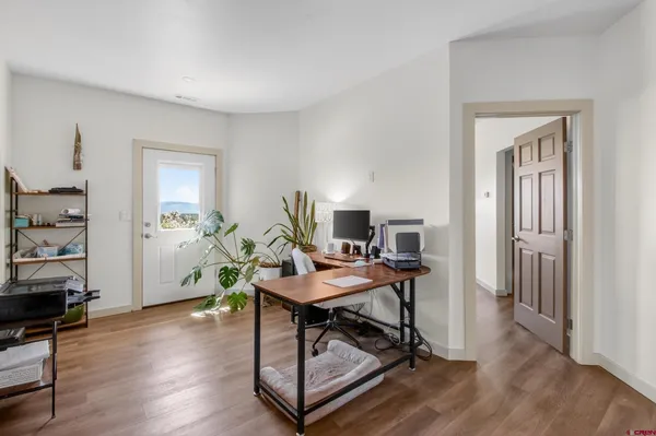 a workspace with furniture and wooden floor