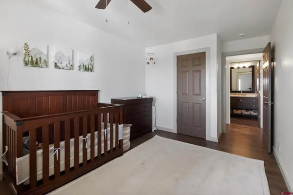 a bedroom with furniture and wooden floor