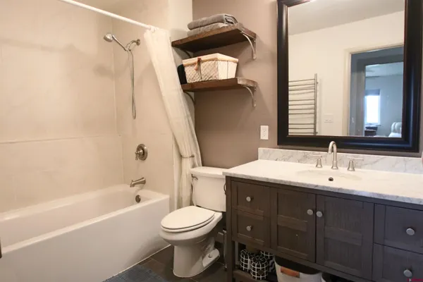a bathroom with a toilet a sink and bathtub