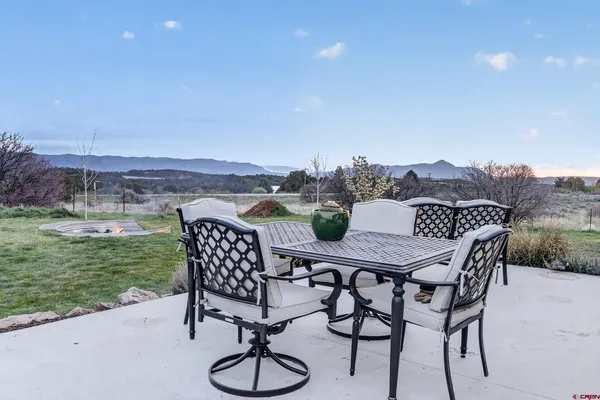 a view of a chairs and table in patio