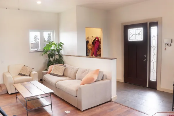 a living room with furniture and a potted plant