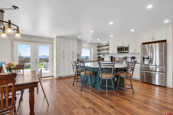 a view of a dining room with furniture kitchen and chandelier