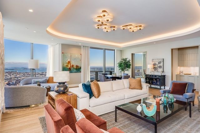 a living room with furniture and a chandelier
