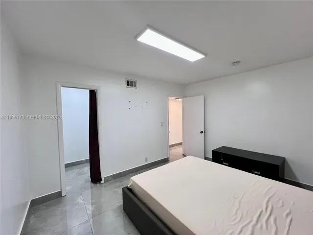a bedroom with a bed and a hallway