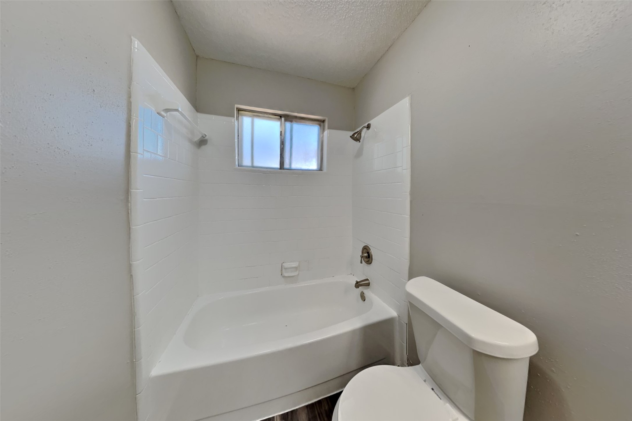 10018 Rippling Fields Drive Houston, TX 77064 - Photo 17 of 21 a white toilet sitting next to a bath tub