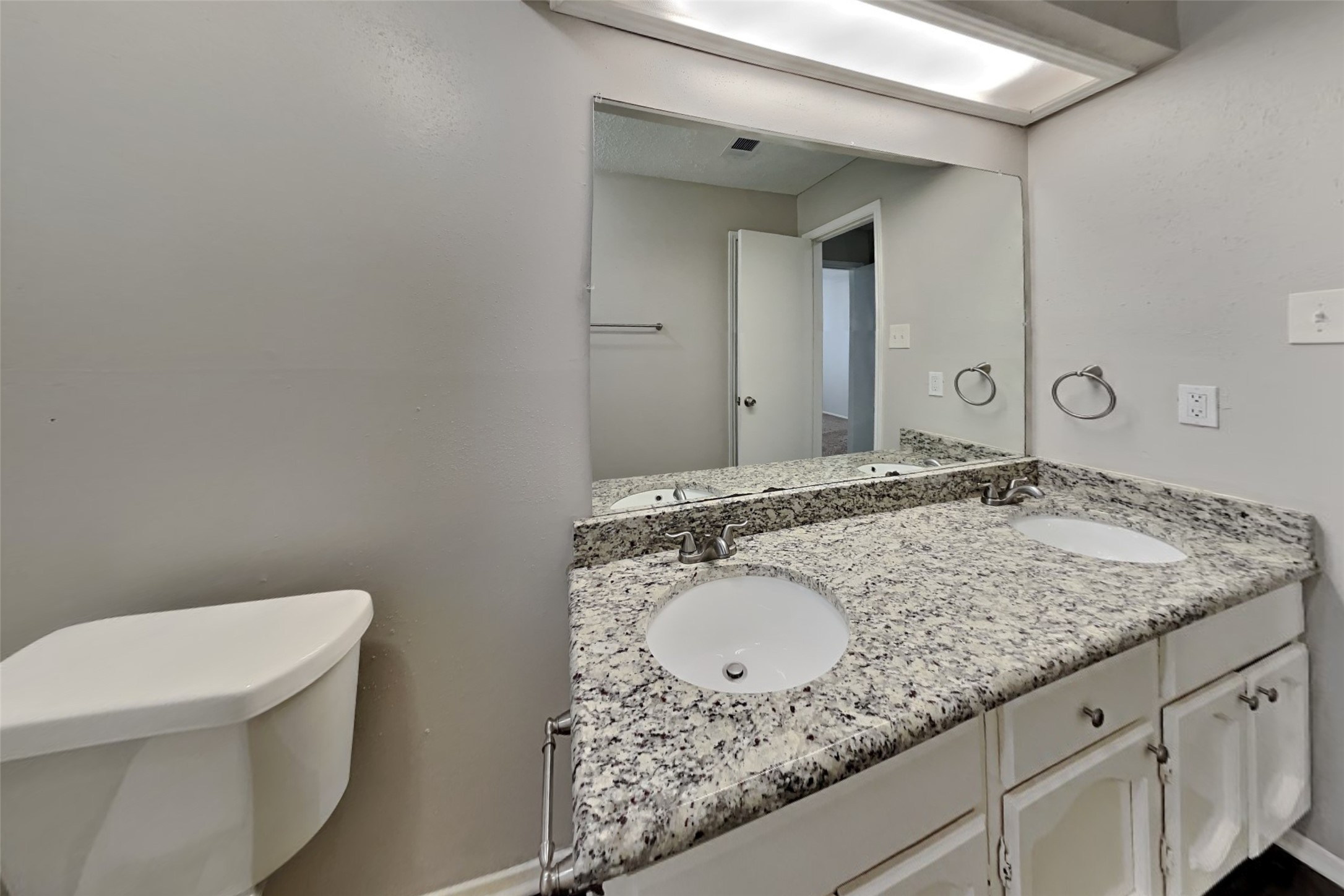 10018 Rippling Fields Drive Houston, TX 77064 - Photo 18 of 21 a bathroom with a granite countertop sink and a mirror