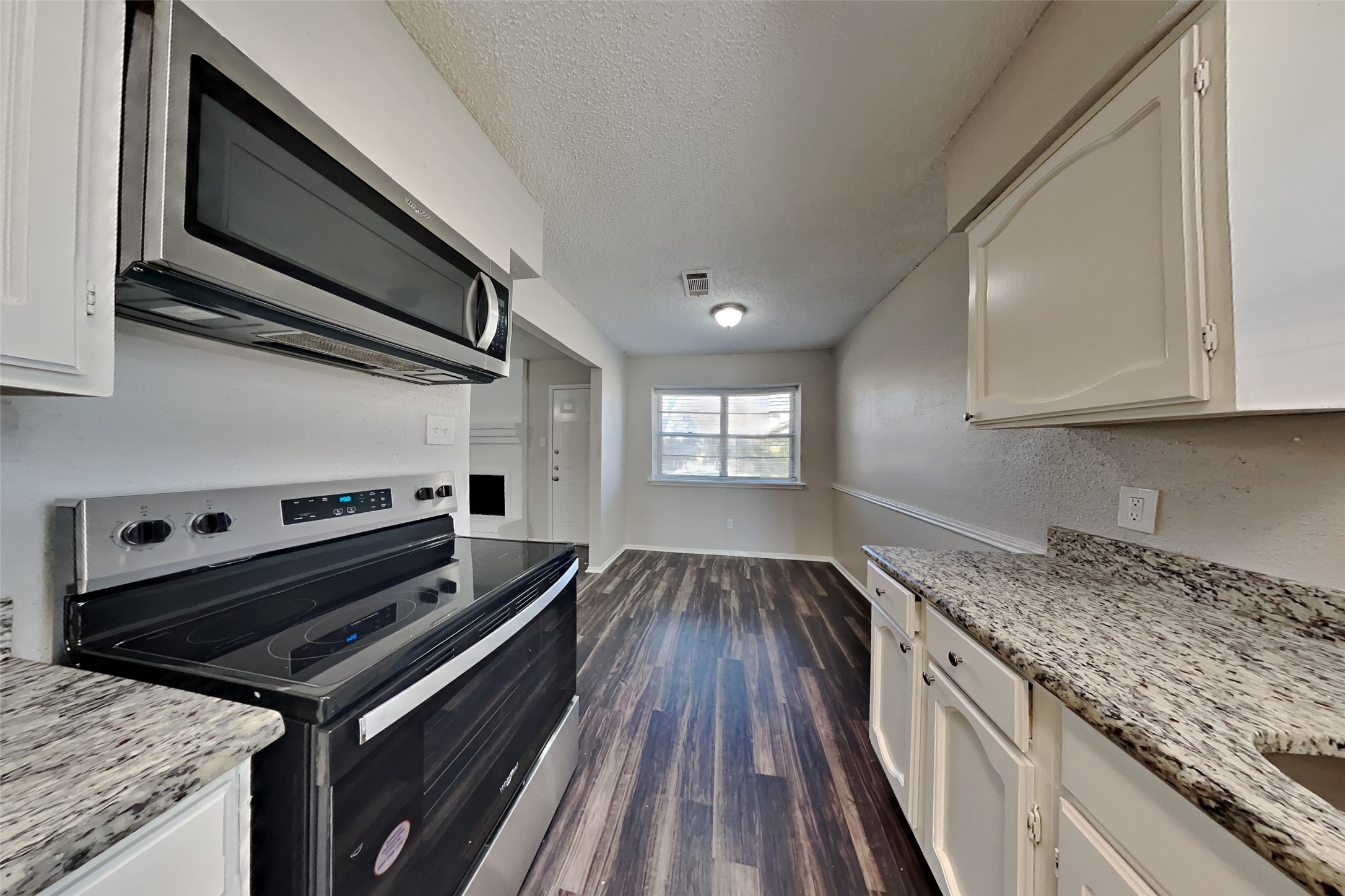 10018 Rippling Fields Drive Houston, TX 77064 - Photo 3 of 21 a kitchen with sink stove and cabinets