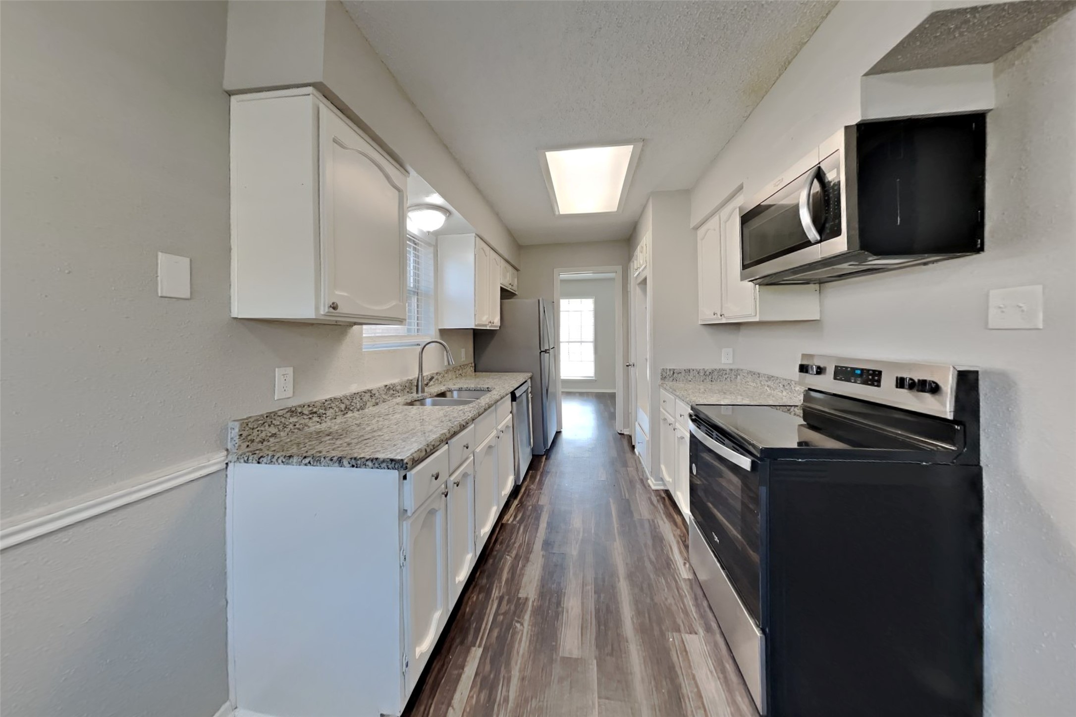 10018 Rippling Fields Drive Houston, TX 77064 - Photo 4 of 21 a kitchen with stainless steel appliances granite countertop a stove top oven a sink dishwasher and a microwave oven on the blue kitchen countertops