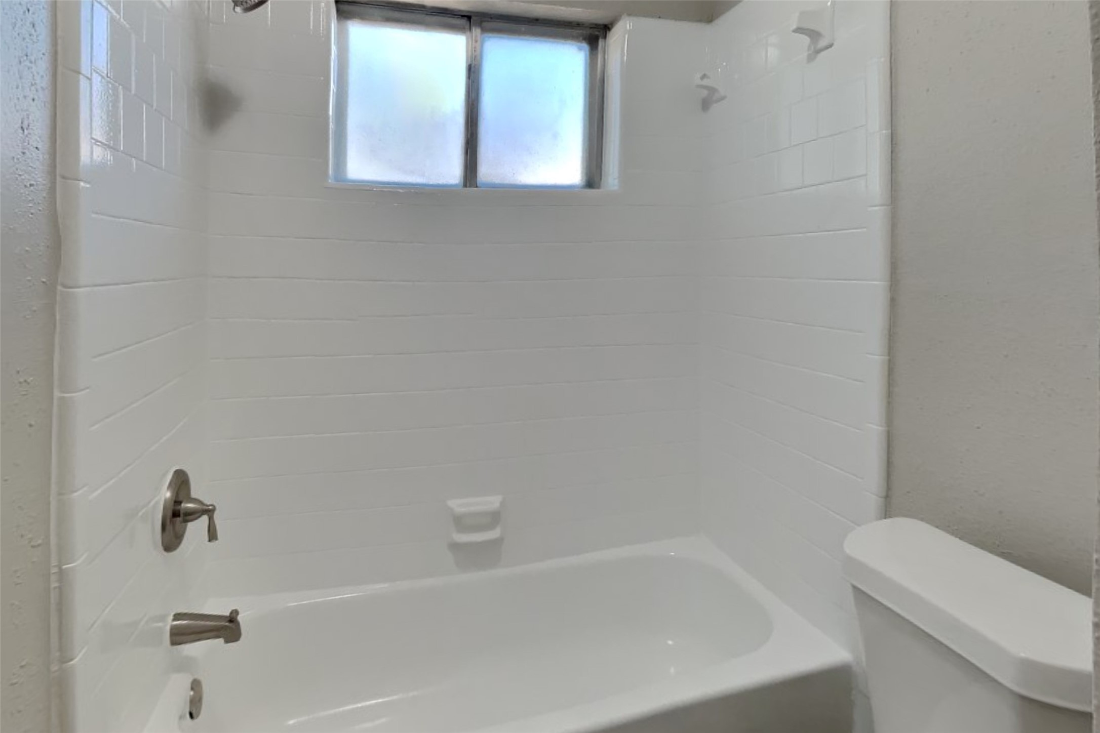 10018 Rippling Fields Drive Houston, TX 77064 - Photo 8 of 21 a white bath tub sitting next to a white toilet