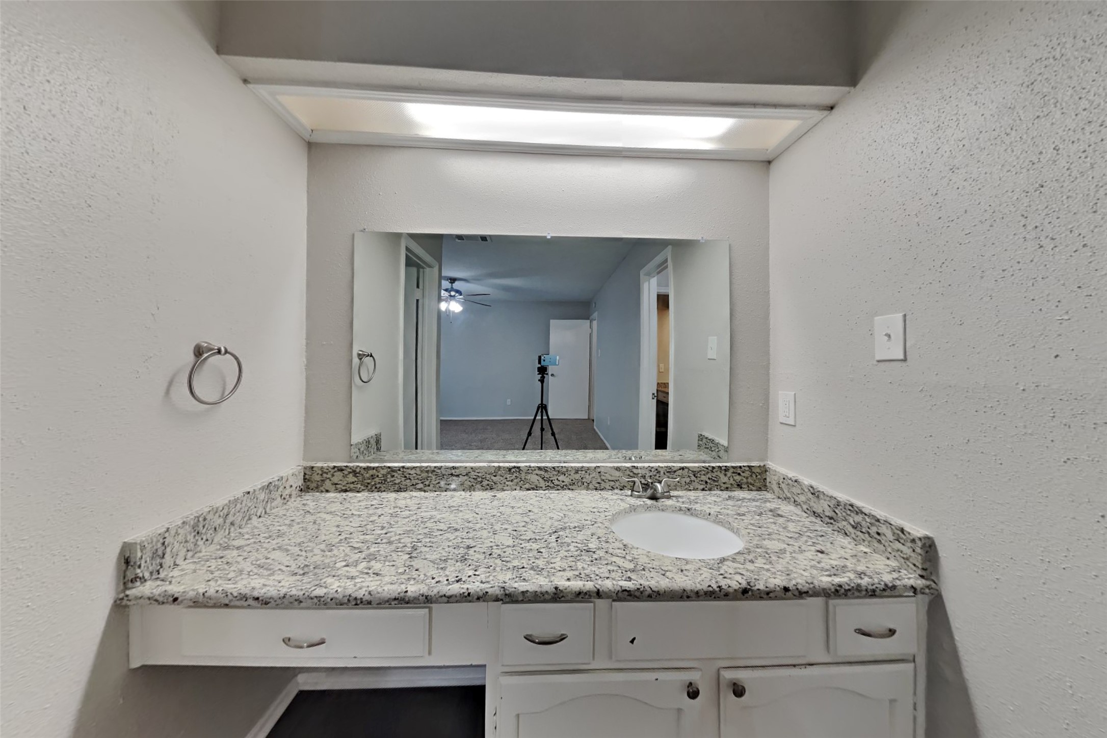 10018 Rippling Fields Drive Houston, TX 77064 - Photo 9 of 21 a bathroom with a granite countertop sink and a mirror