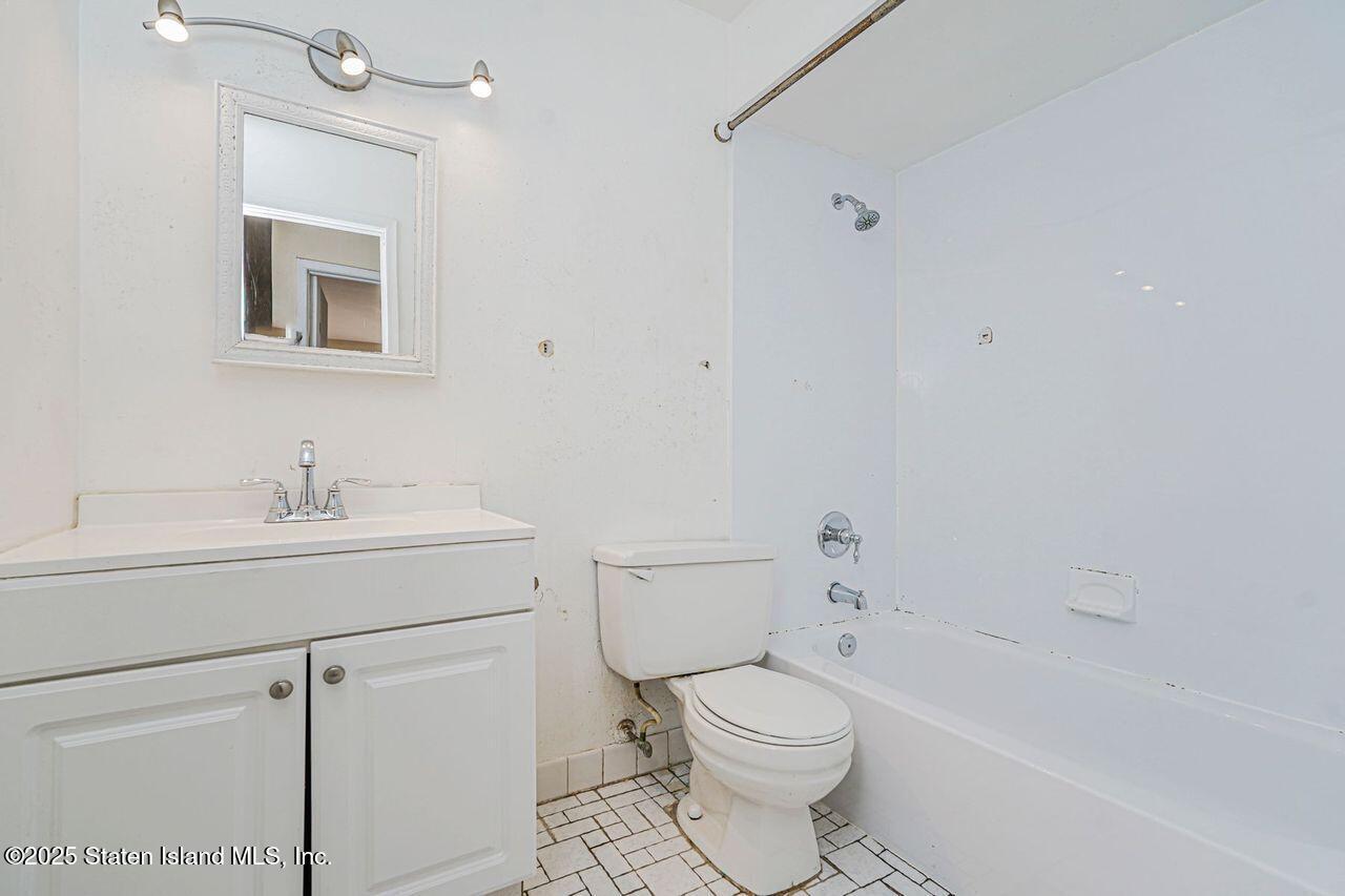 15 Parkview Loop Staten Island, NY 10314 - Photo 23 of 25 a bathroom with a sink toilet a vanity and shower