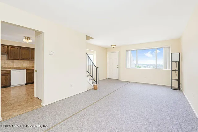 a view of empty room with a fireplace