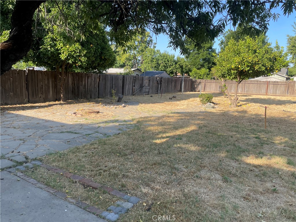 2441 Madrone Street Sutter, CA 95982 - Photo 34 of 45 a view of a backyard with large trees and wooden fence