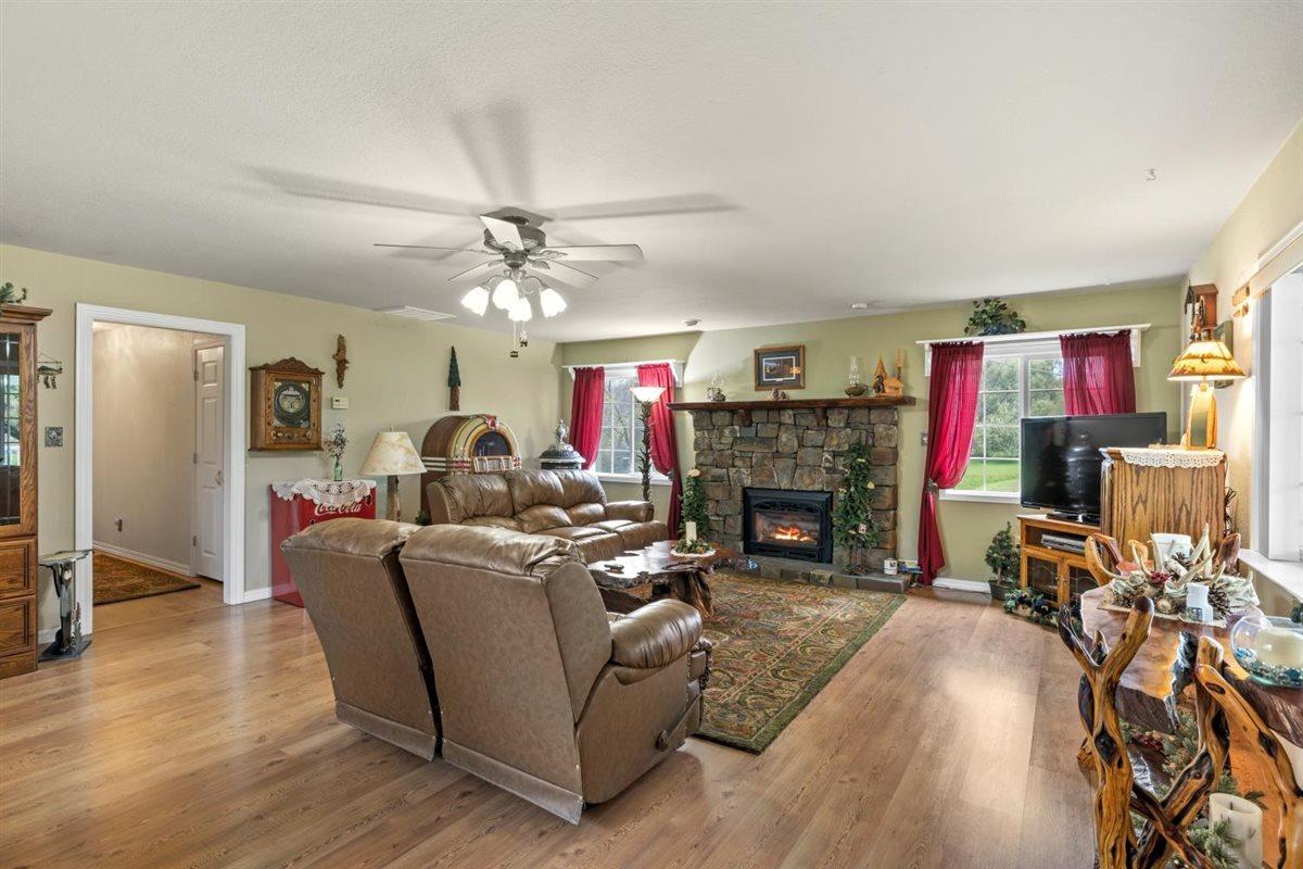5383 Dream Ranch Circle Placerville, CA 95667 - Photo 32 of 91 a living room with furniture a fireplace and a chandelier