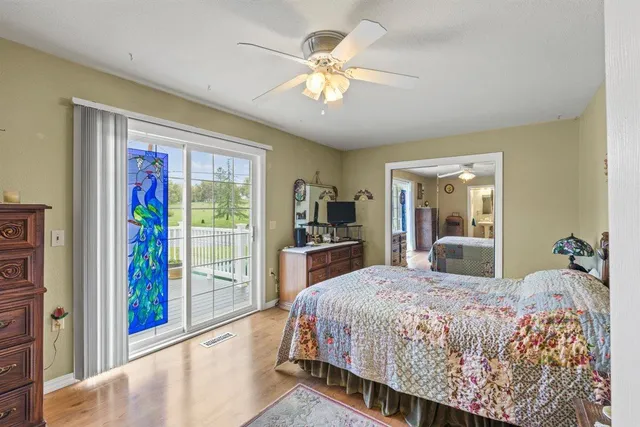 a view of a lake with a yard and large trees