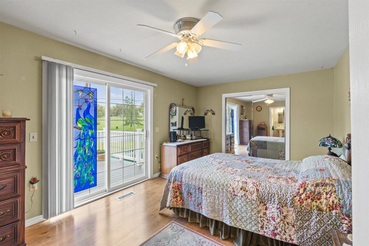 5383 Dream Ranch Circle Placerville, CA 95667 - Photo 35 of 91 a bedroom with a large bed and a chandelier