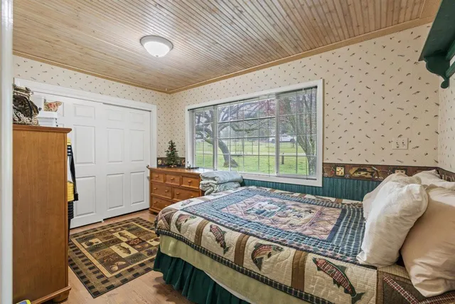 an aerial view of a house with a yard and swimming pool
