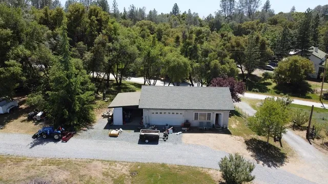 a view of a lake with a yard and large trees