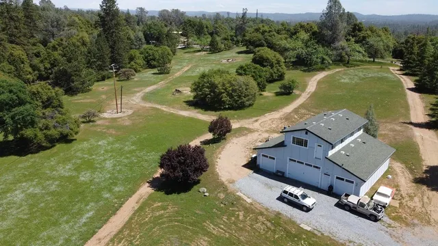 a view of side of snow with trees in the background