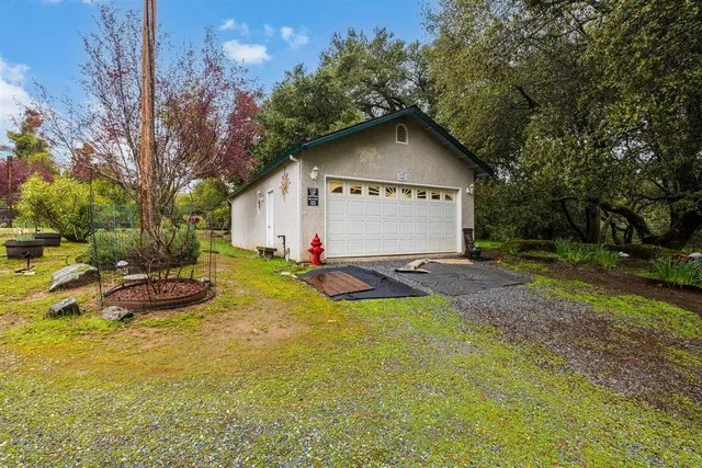 a view of a lake with a yard and large trees