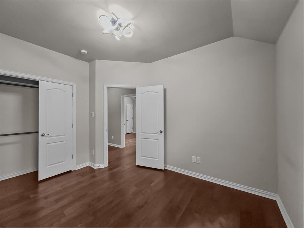 3205 Ridgeway Drive McKinney, TX 75071 - Photo 19 of 27 a view of an empty room with wooden floor and cabinet
