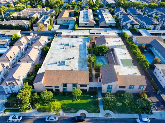 an aerial view of multiple houses with yard