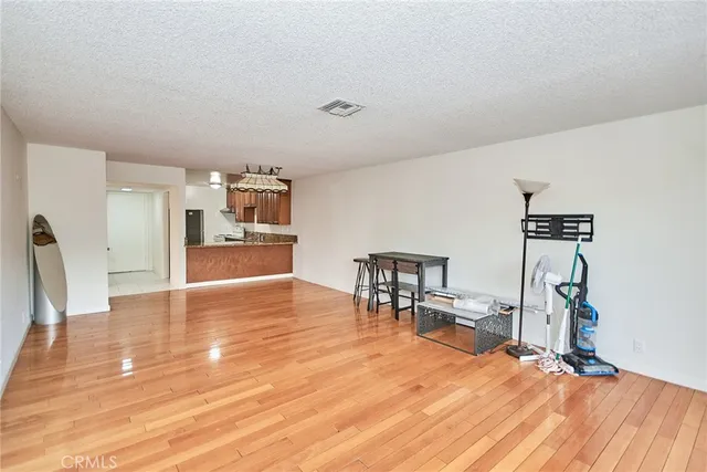 a view of a room with furniture and wooden floor
