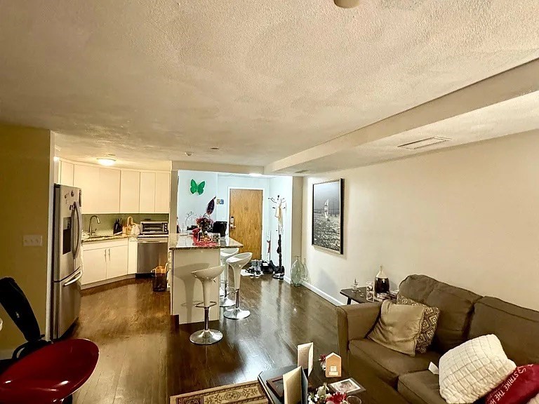 205 Ferry Street, Unit 101 Everett, MA 02149 - Photo 3 of 10 a living room with furniture and a table