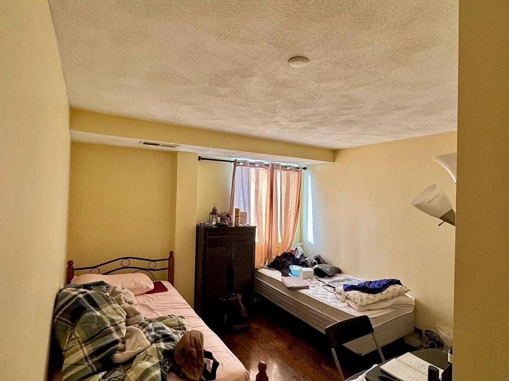 205 Ferry Street, Unit 101 Everett, MA 02149 - Photo 7 of 10 a bedroom with bed and a window