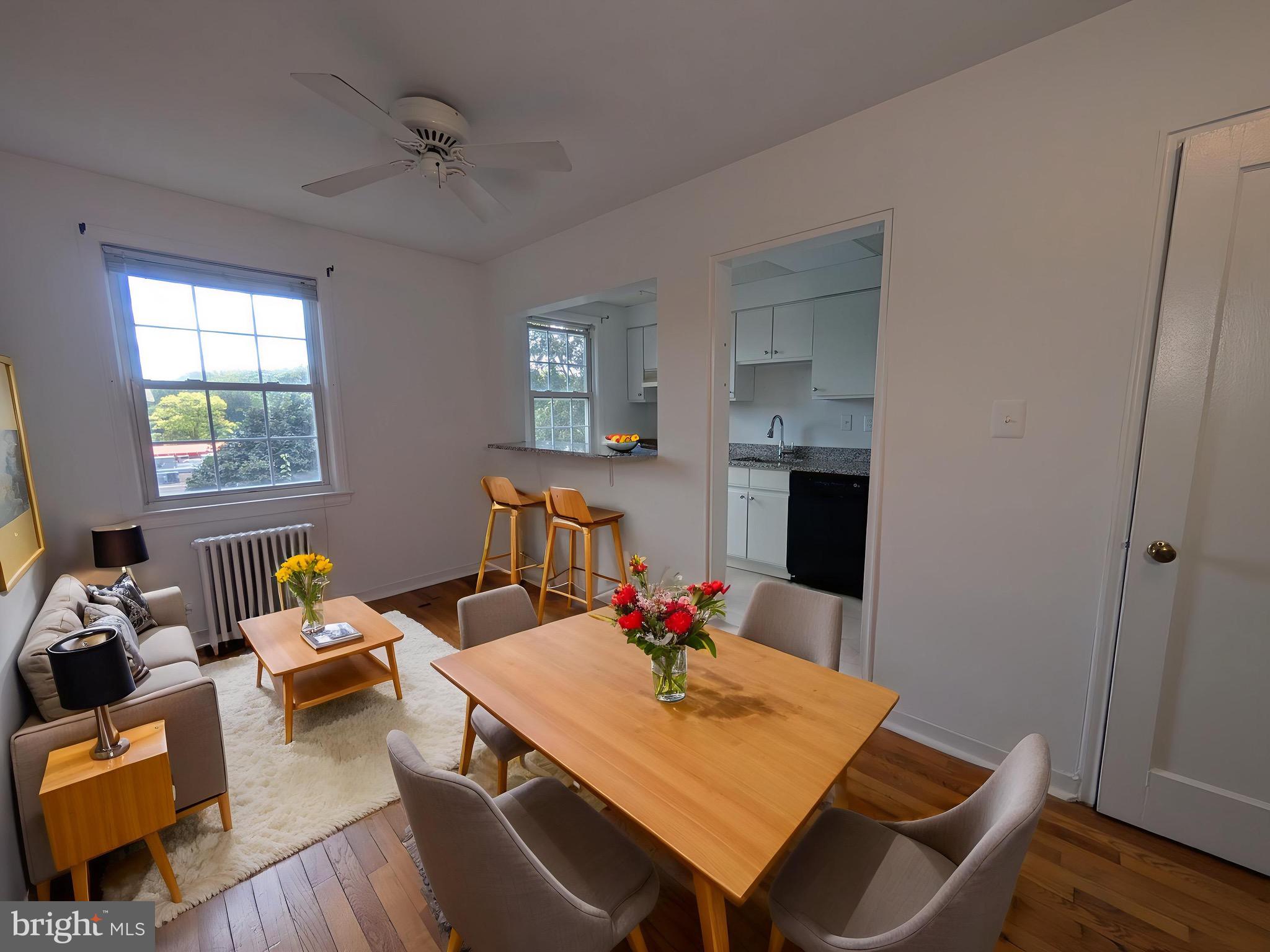2406 Colston Drive, Unit 302 Silver Spring, MD 20910 - Photo 1 of 21 a view of a dining room with furniture window and wooden floor