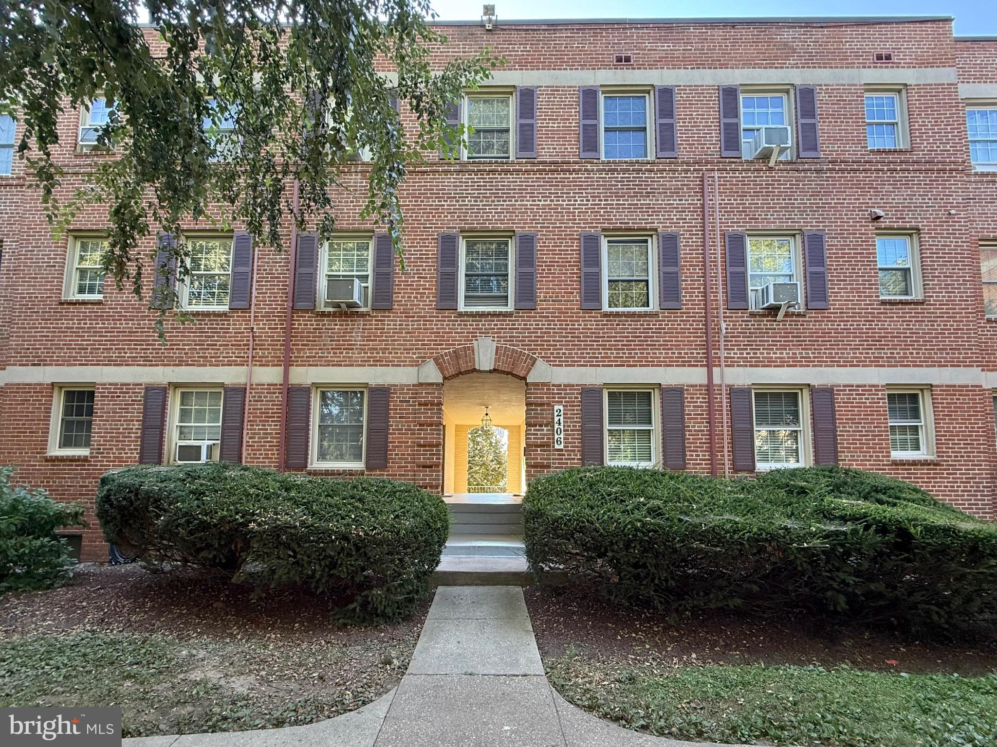 2406 Colston Drive, Unit 302 Silver Spring, MD 20910 - Photo 11 of 21 a view of a brick building next to a yard