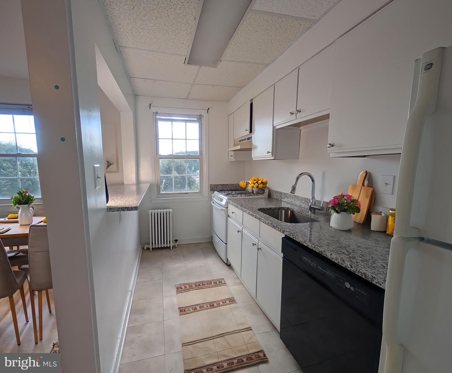 2406 Colston Drive, Unit 302 Silver Spring, MD 20910 - Photo 3 of 21 a kitchen with stainless steel appliances a sink a stove a refrigerator and cabinets