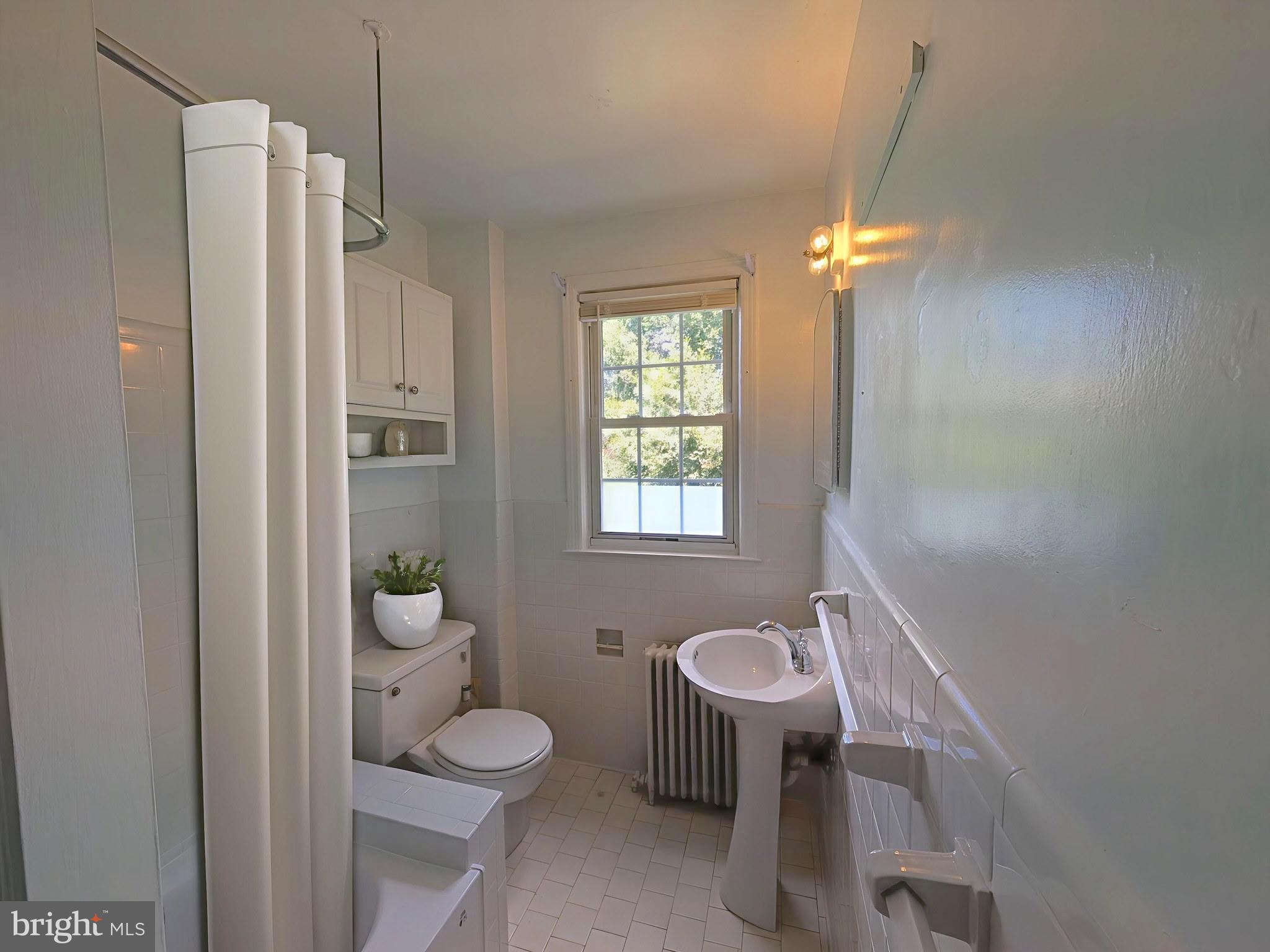 2406 Colston Drive, Unit 302 Silver Spring, MD 20910 - Photo 4 of 21 a bathroom with a sink toilet a mirror and shower