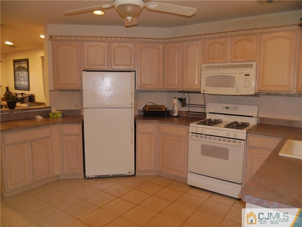 3 Melville Road Edison, NJ 08817 - Photo 9 of 20 a kitchen with a refrigerator sink stove and cabinets