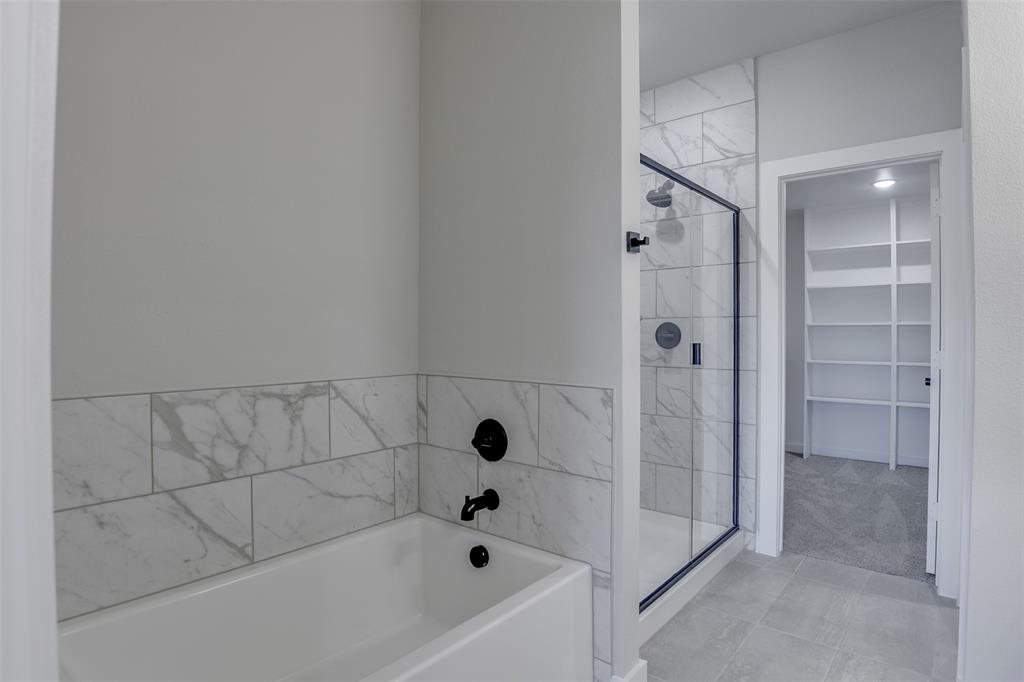 4062 Clovis Street Midlothian, TX 76065 - Photo 16 of 19 a bathroom with a bathtub and shower