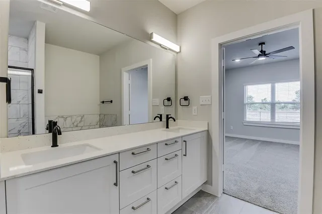 a bathroom with a double vanity sink and mirror
