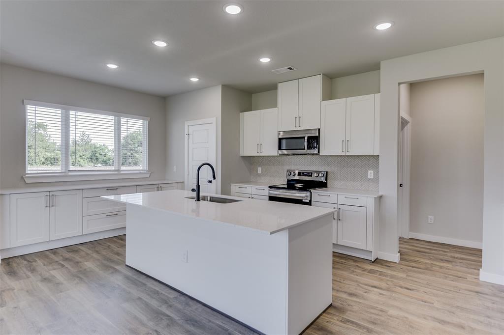 4062 Clovis Street Midlothian, TX 76065 - Photo 8 of 19 a kitchen with stainless steel appliances granite countertop a sink dishwasher a refrigerator and a stove with wooden floor
