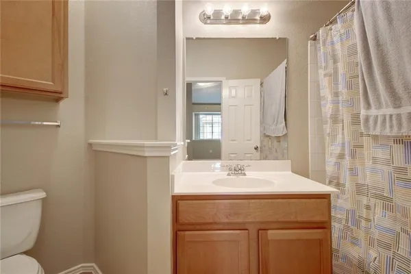 a bathroom with a tub sink and mirror