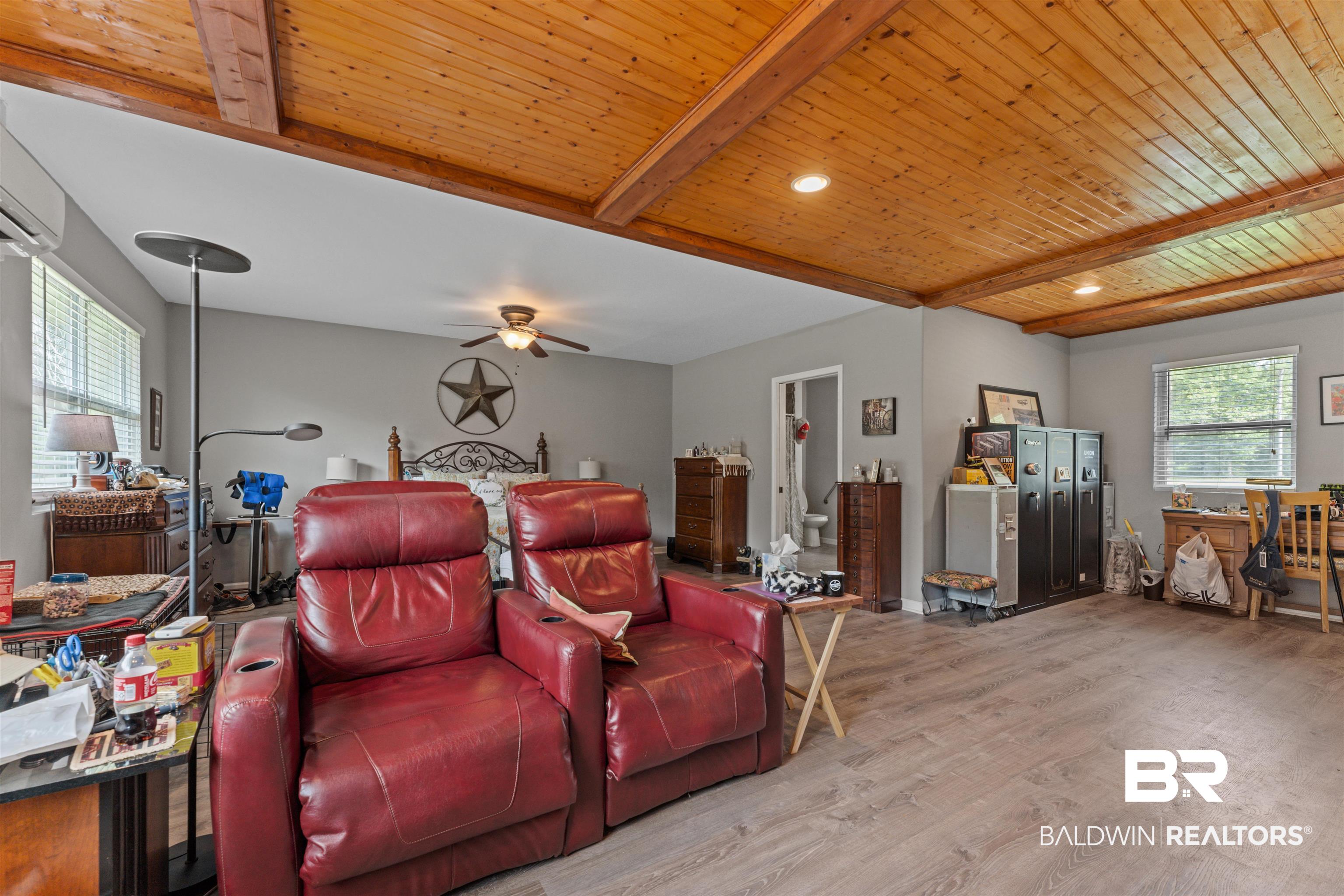 32794 Antietam Road Lillian, AL 36549 - Photo 18 of 20 Cinema room with wood finished floors, ceiling fan, and a wooden ceiling with exposed beams